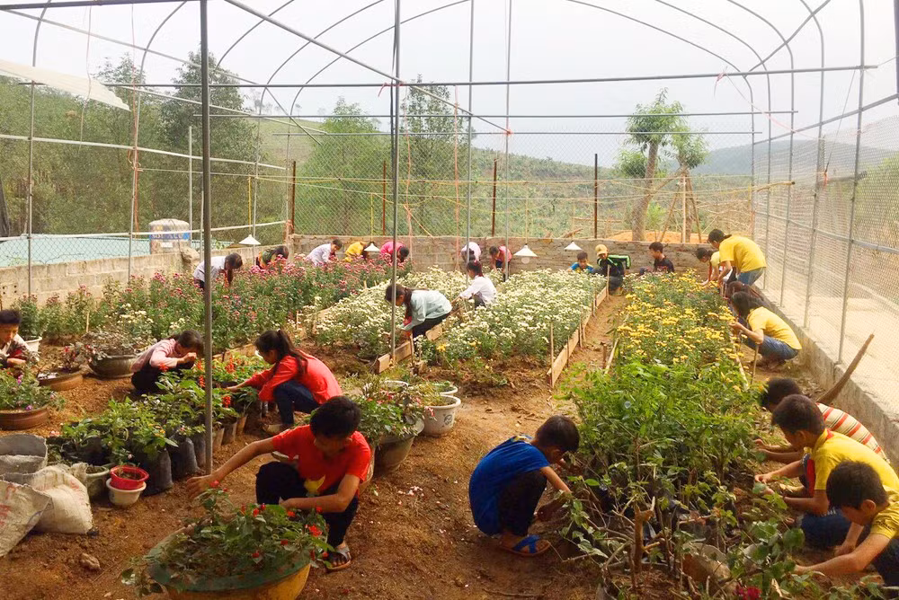 Học sinh Trường Tiểu học và THCS Cốc Mỳ chăm sóc vườn hoa làm đẹp cho trường.
