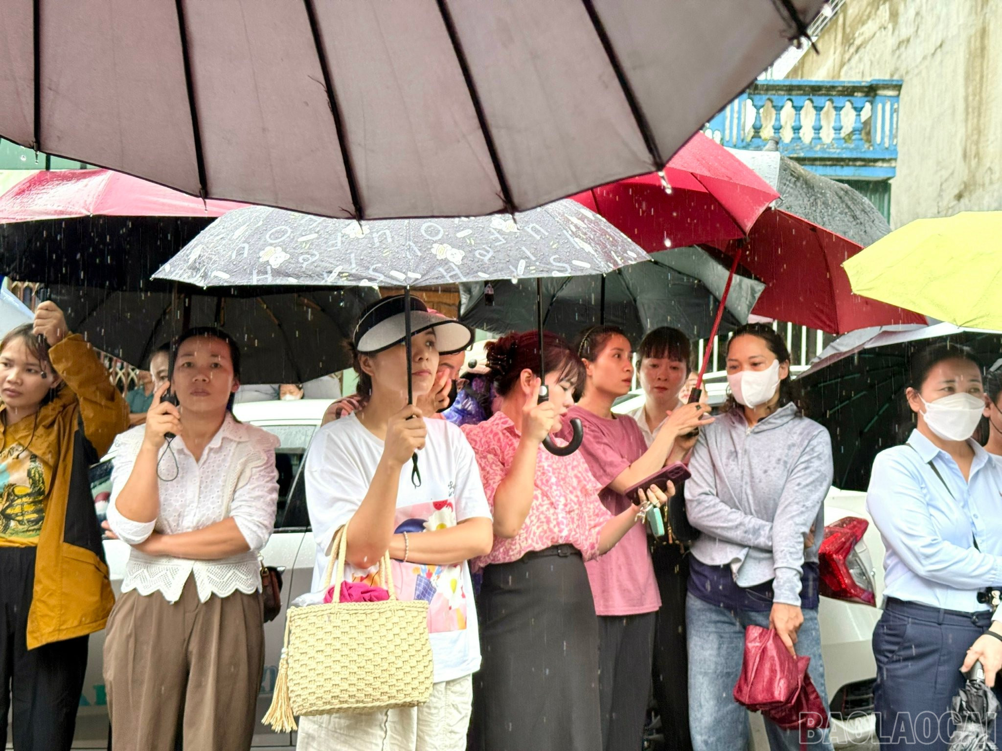 Parents of students stood in the heavy rain waiting for candidates to finish the exam. baolaocai-br_z6670247398119-8ae5ae411b19949c252e57835780b048.jpg
