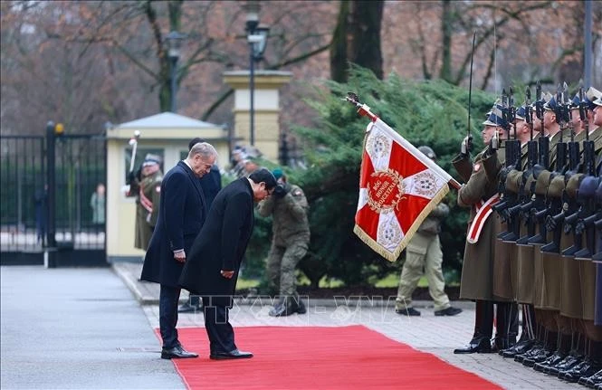 Thủ tướng Phạm Minh Chính và Thủ tướng Cộng hòa Ba Lan Donald Tusk duyệt đội danh dự. Ảnh: Dương Giang/TTXVN
