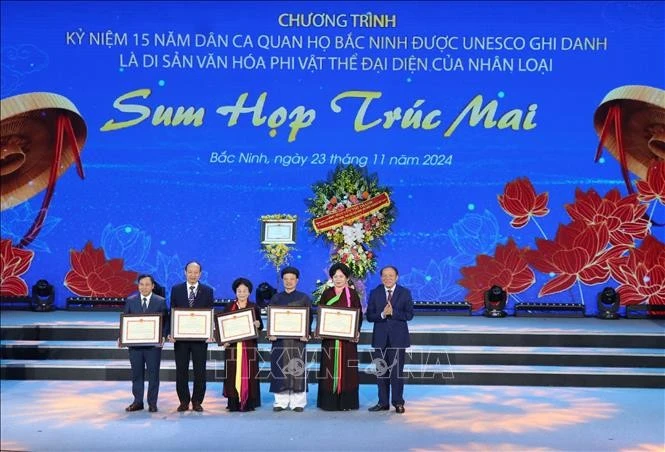 Bộ trưởng Bộ Văn hóa, Thể thao và Du lịch Nguyễn Văn Hùng tặng Bằng khen cho các tập thể có thành tích xuất sắc trong công tác bảo tồn, phát huy giá trị di sản Dân ca Quan họ Bắc Ninh. Ảnh: Thái Hùng/TTXVN