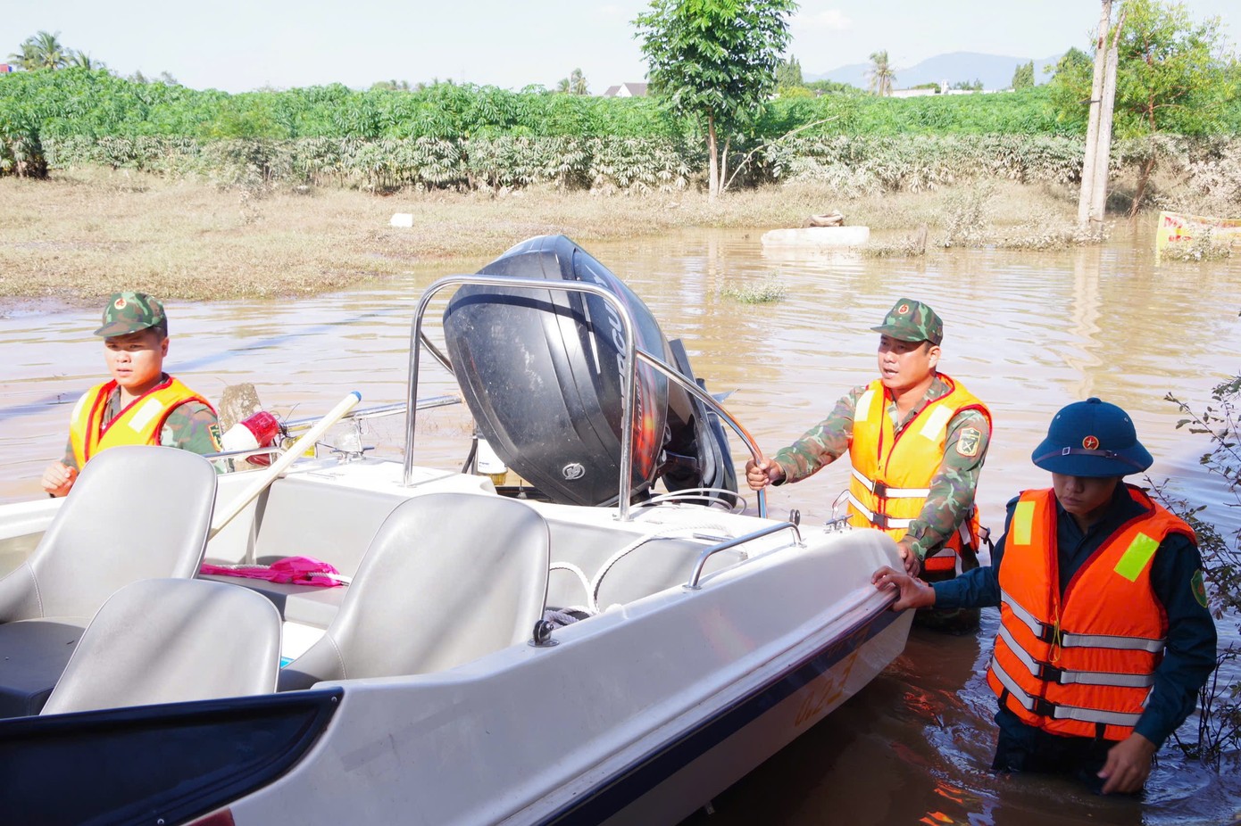 Lực lượng chức năng dùng ca nô tiếp cận người dân phường Hàm Thắng tại các điểm còn ngập.
