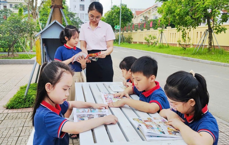 Học sinh Trường Tiểu học Trần Nhân Tông (Đông A, Ninh Bình) trong buổi ngoại khóa - đọc sách ngoài trời. giao-duc.jpg