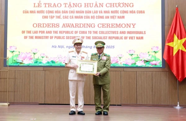 Phó Thủ tướng, Bộ trưởng Bộ Công an Lào Vilay Lakhamphong trao Huân chương Tự do hạng Nhất tặng Bộ trưởng Lương Tam Quang.