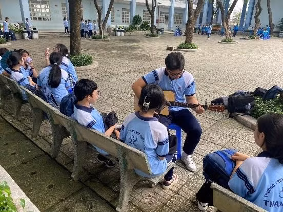 Các em học sinh trường THPT Thạnh Lộc cùng nhau trò chuyện, đàn hát trong giờ ra chơi.