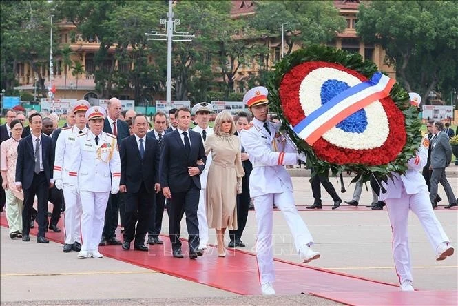 Tổng thống Pháp Emmanuel Macron và Phu nhân đến đặt vòng hoa và vào Lăng viếng Chủ tịch Hồ Chí Minh. (Ảnh: TTXVN)