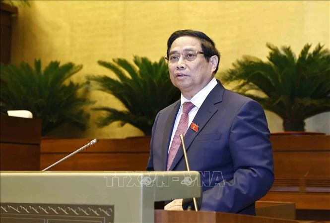 Thủ tướng Phạm Minh Chính trình bày Báo cáo kết quả thực hiện kế hoạch phát triển kinh tế - xã hội năm 2024, dự kiến kế hoạch phát triển kinh tế - xã hội năm 2025. Ảnh: Doãn Tấn/TTXVN