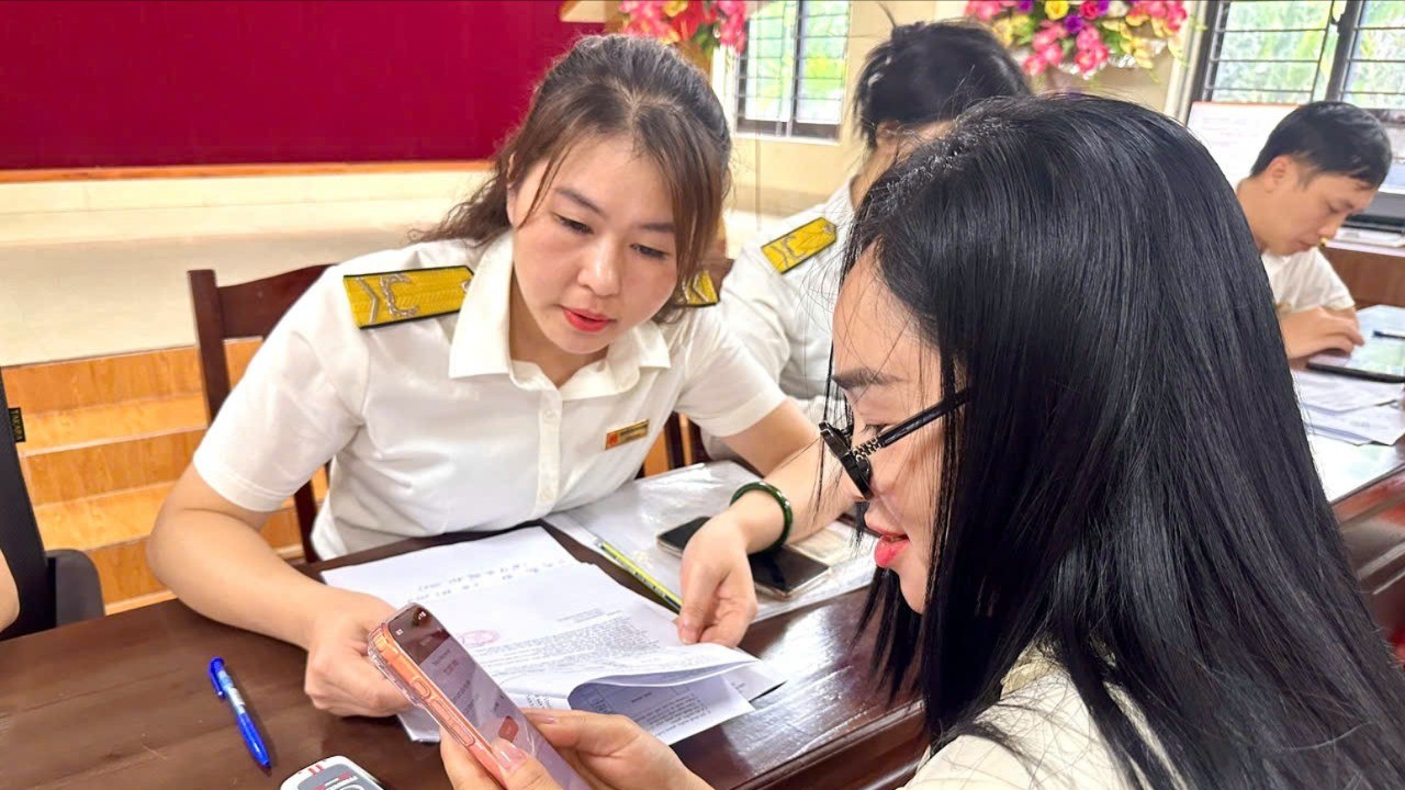 Công chức thuế tại các điểm trực hướng dẫn người dân cài đặt ứng dụng eTax mobile để nộp thuế phi nông nghiệp bằng phương thức điện tử. thuc7m-1713.jpg