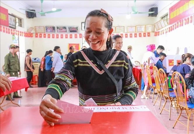 Khoảnh khắc cử tri bỏ lá phiếu vào hòm phiếu - hành động thể hiện quyền làm chủ của nhân dân trong đời sống chính trị của đất nước.