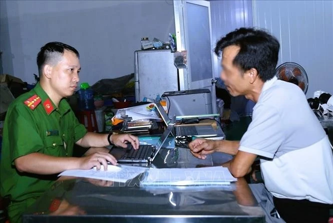 Công an làm việc với đối tượng Lê Văn Tình. Ảnh: Công an Đồng Nai/TTXVN phát