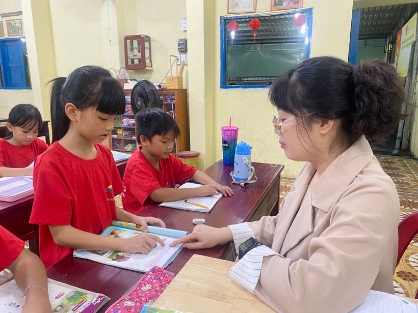 Tình nguyện viên hướng dẫn các em lớp 1 tại lớp học tình thương phường Hiệp Thành