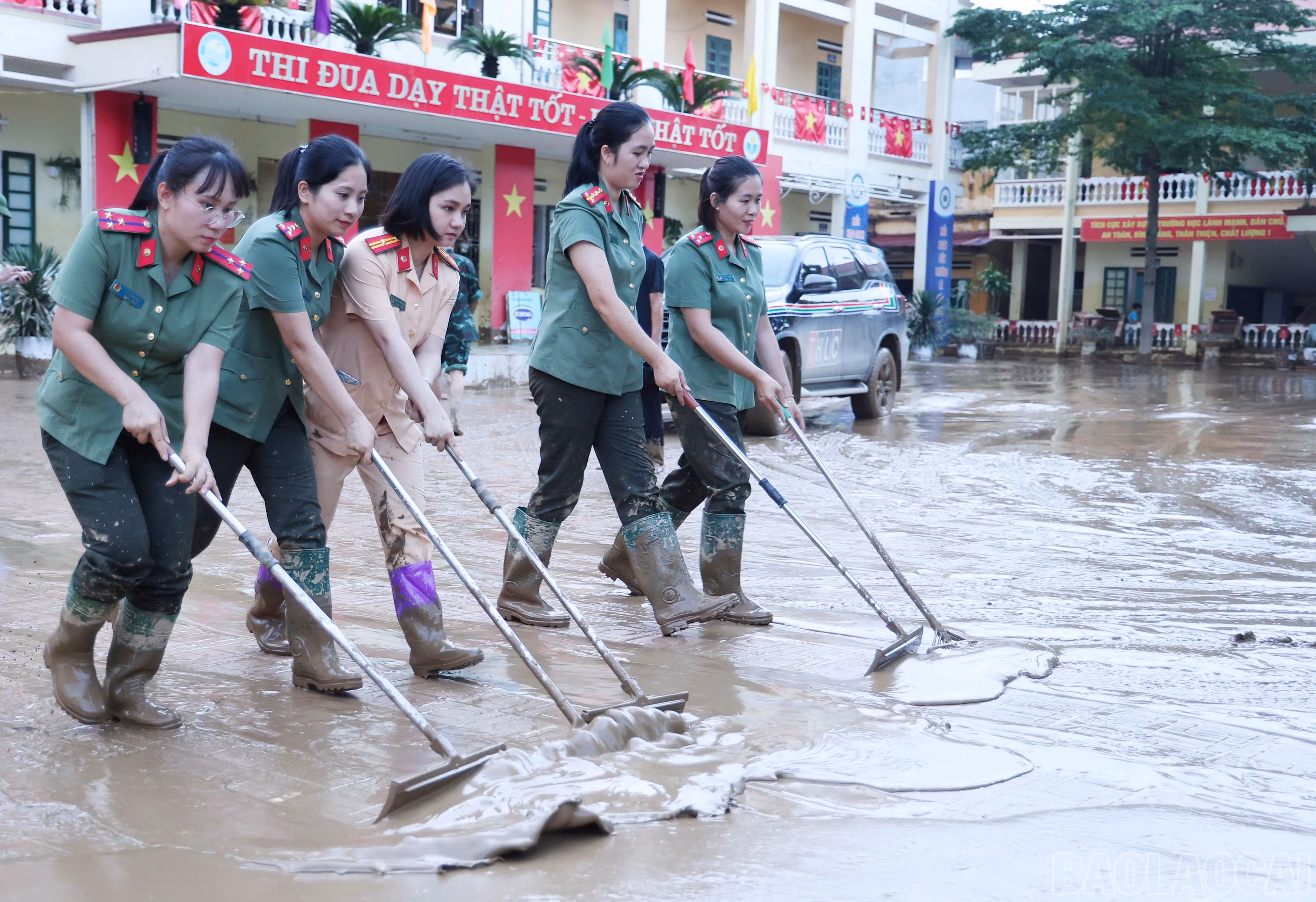 Bộ đội và công an giúp dọn bùn đất tại Trường Tiểu học Hồng Thái, phường Yên Bái.