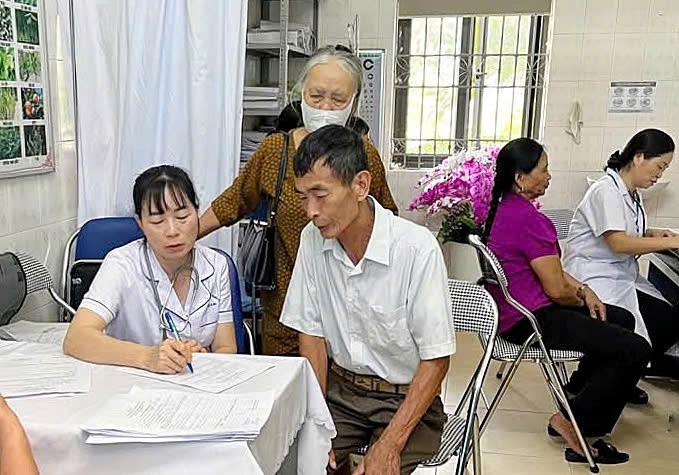 Cán bộ y tế tư vấn chăm sóc sức khỏe cho người cao tuổi. z6668016063023-9031ab0d32dde2f40eb334127c31a83d.jpg