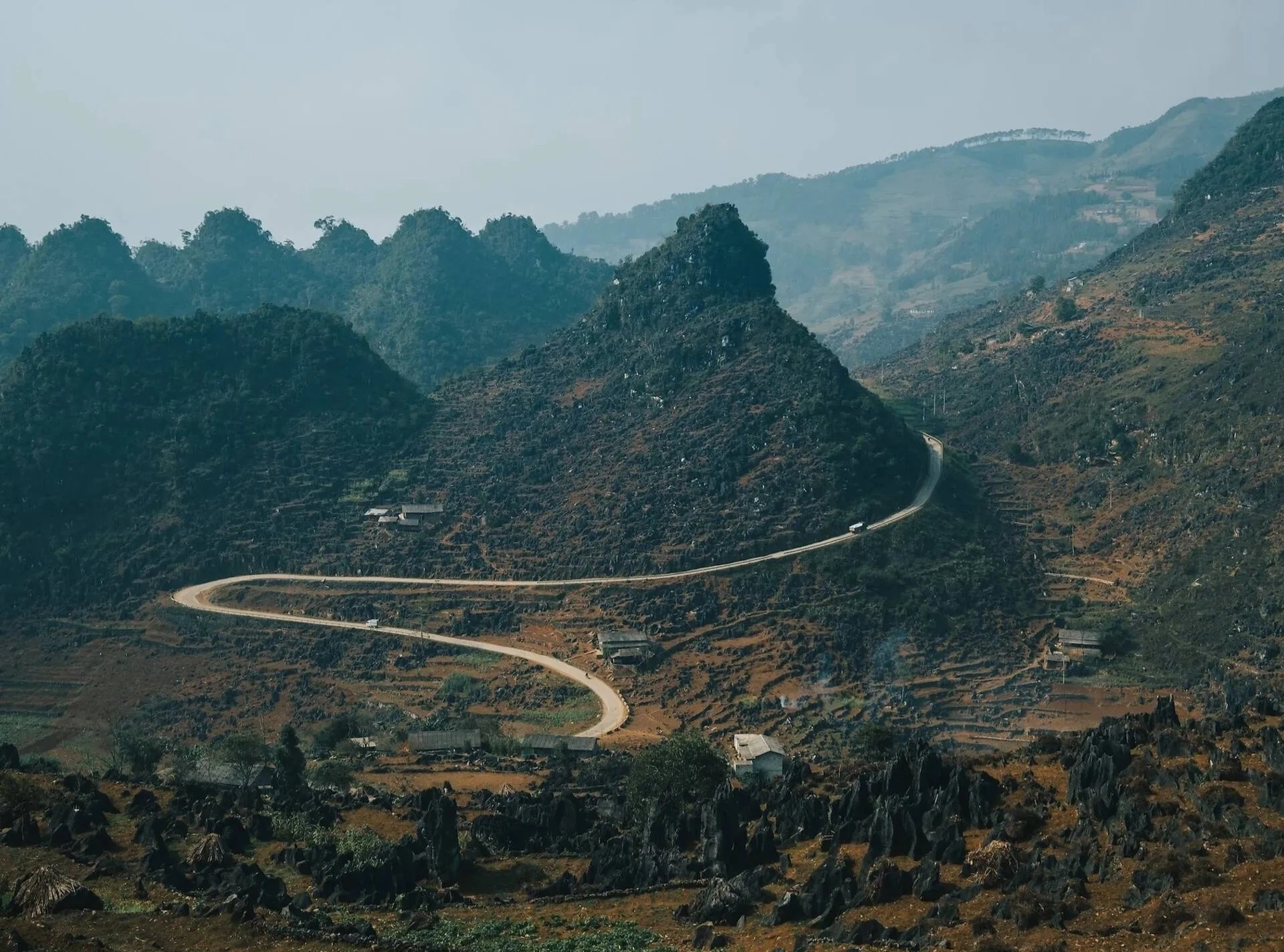 Nằm ở tận cùng phía bắc của Việt Nam, địa danh Hà Giang lại cực kỳ nổi tiếng trên thế giới. Một khi đã đến đây, bạn sẽ hiểu. Những con đèo quanh co, những thửa ruộng bậc thang và 43 dân tộc khác nhau sinh sống đã tạo nên vẻ đẹp huyền ảo cho Hà Giang. Hai đoạn đường đặc biệt thu hút sự chú ý, và điều đó hoàn toàn xứng đáng. Đèo Thẩm Mã uốn lượn qua sáu khúc cua tay áo liên tiếp, trong khi đèo Mã Pí Lèng men theo sườn núi, nhìn xuống sông Nho Quế ở độ cao khoảng 900 mét. Ở Hà Giang, bạn sẽ được chiêm ngưỡng những dãy núi trùng điệp trải dài đến tận chân trời, với những thửa ruộng bậc thang. Hàng nghìn năm lao động vất vả của con người đã khiến những ngọn núi này thành những cánh đồng lúa rộng lớn tuyệt đẹp như ngày nay