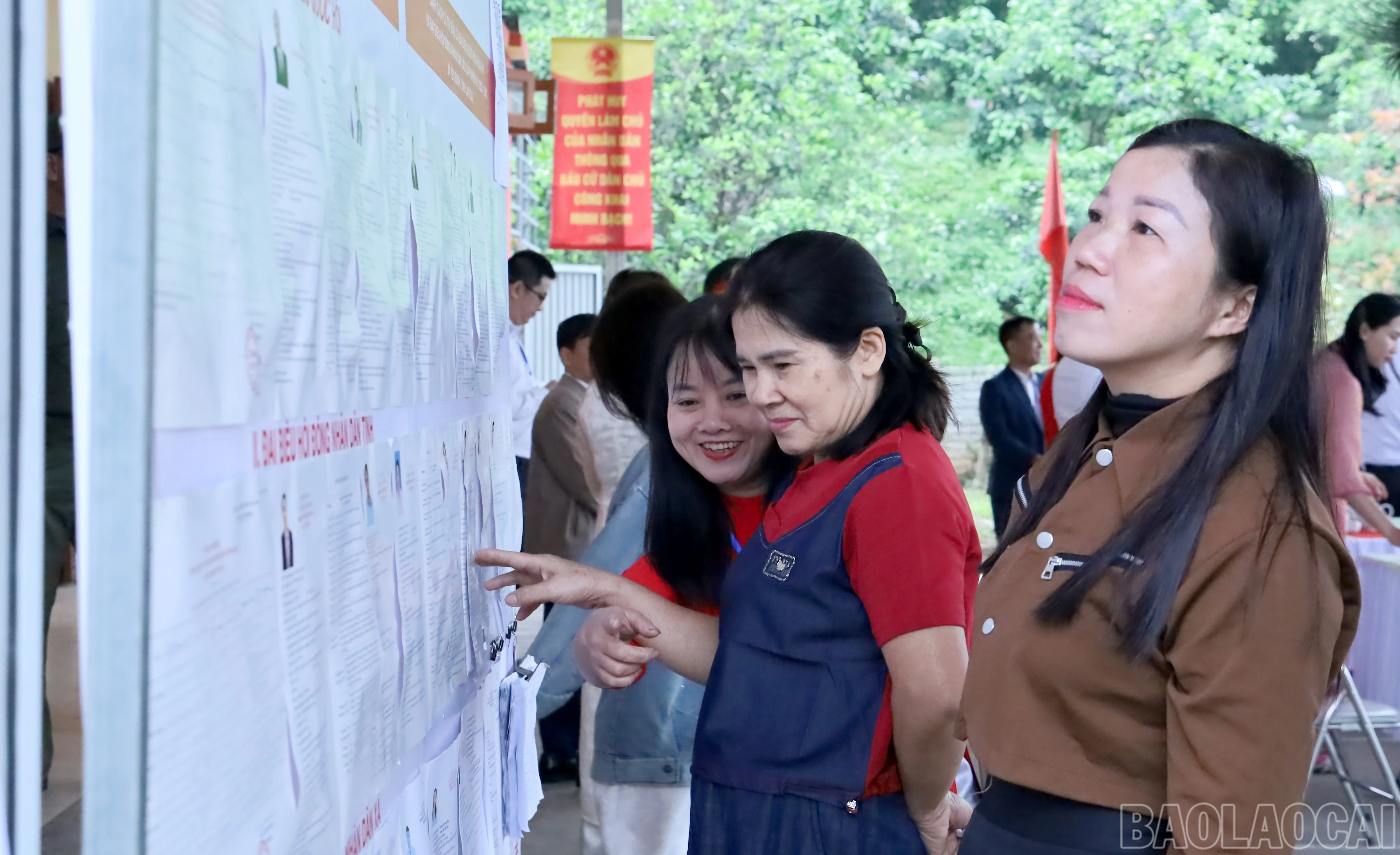 Cử tri thôn Miếu Hạ nghiên cứu thông tin ứng cử viên trước khi tham gia bỏ phiếu.