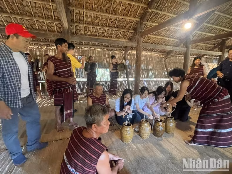 Du khách thưởng thức rượu cần cùng đồng bào các dân tộc ở Làng.