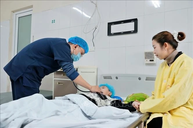 Bác sĩ thăm khám cho bệnh nhi mắc cúm A đang điều trị tại Khoa Nhi, Bệnh viện Bệnh nhiệt đới Trung ương.