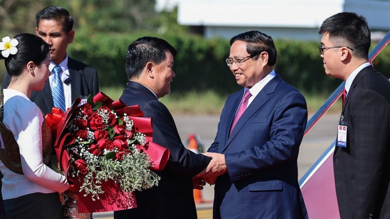 Các quan chức Chính phủ Lào nồng nhiệt chào đón Thủ tướng Phạm Minh Chính tại chân cầu thang máy bay.