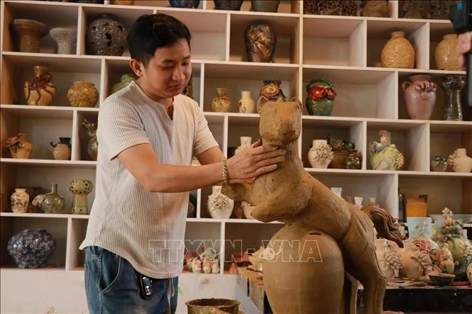 Nghệ nhân Nguyễn Viết Lâm tạo hình cho sản phẩm "Ngựa tài lộc" ở làng gốm Thanh Hà (phường Hội An, TP Đà Nẵng).