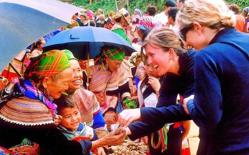 Du khách quốc tế giao lưu với người dân địa phương tại chợ phiên Cốc Ly.