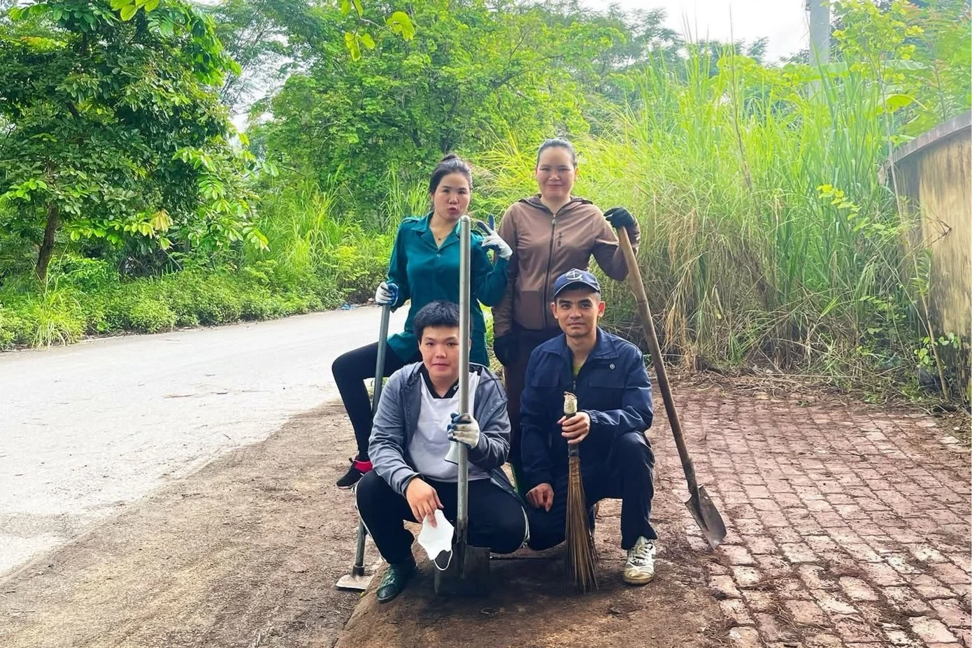 Anh Khánh (đội mũ) cùng nhóm chụp ảnh sau khi một đoạn đường đã được dọn dẹp xong.