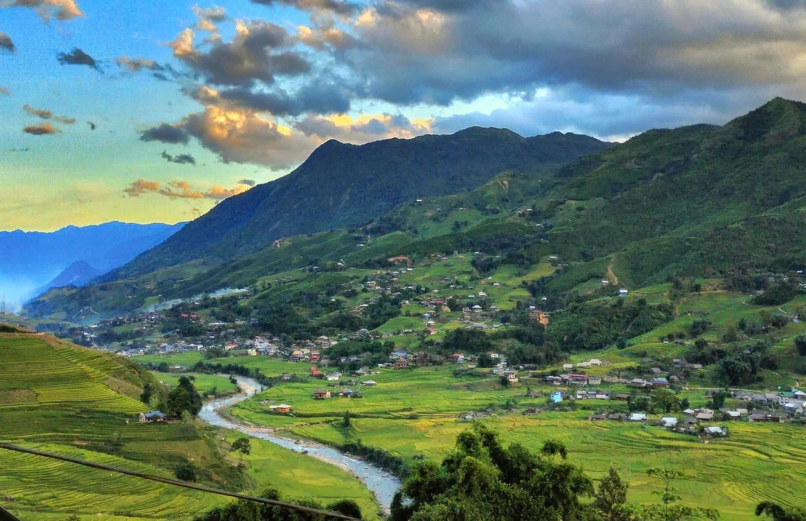 Từ trên cao nhìn xuống, bản Lao Chải hiện lên thanh bình, xanh mướt với điểm nhấn là những ngôi nhà gỗ.