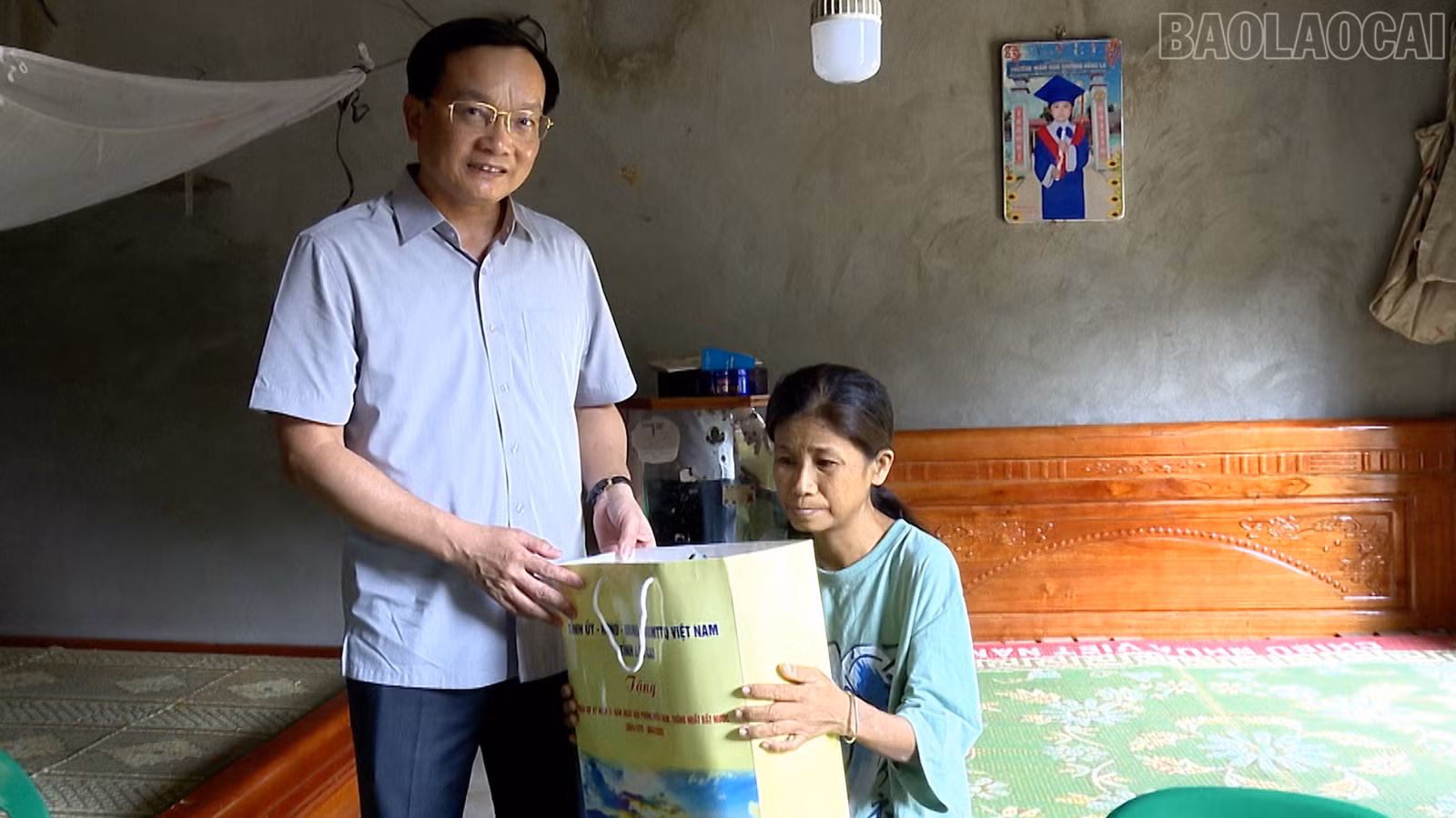 Đồng chí Đỗ Đức Minh - Giám đốc Sở Tài chính tặng quà cho bà Hoàng Thị Thanh là hộ nghèo, có hoàn cảnh khó khăn.