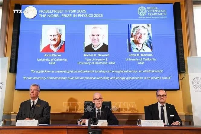 Chân dung 3 nhà khoa học người Mỹ đoạt giải Nobel Vật lý 2025 (trên màn hình, từ trái sang): John Clarke, Michel H. Devoret và John M. Martinis. Ảnh tư liệu: THX/TTXVN