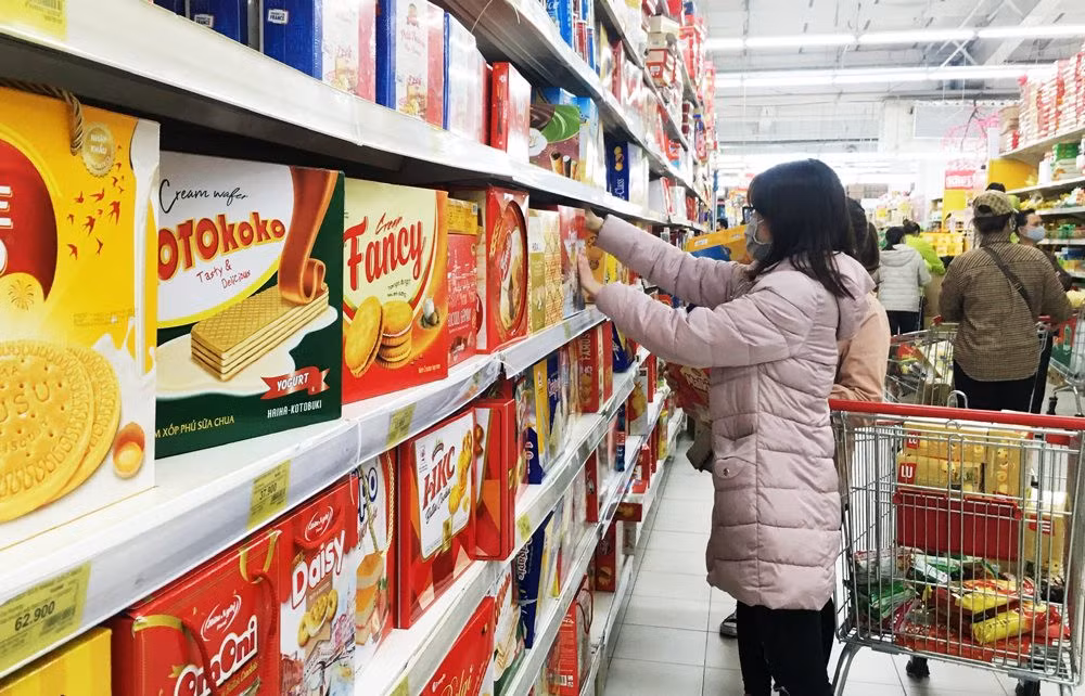 Người tiêu dùng chọn mua bánh kẹo Việt tại siêu thị Big C (quận Cầu Giấy).