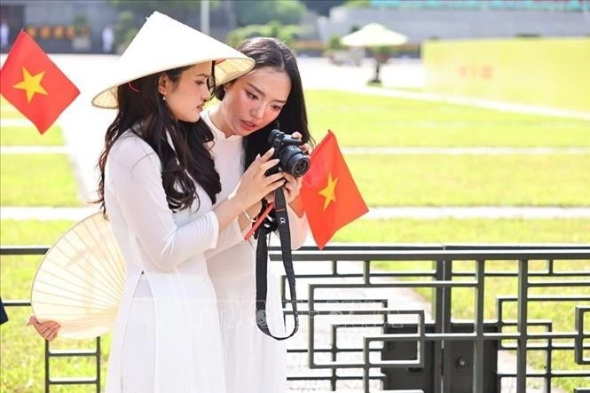 Trang phục áo dài trắng truyền thống được giới trẻ ưa chuộng để chụp hình, lưu giữ những khoảnh khắc ý nghĩa hướng tới kỷ niệm 80 năm Cách mạng tháng Tám thành công và Quốc khánh nước Cộng hòa xã hội chủ nghĩa Việt Nam.