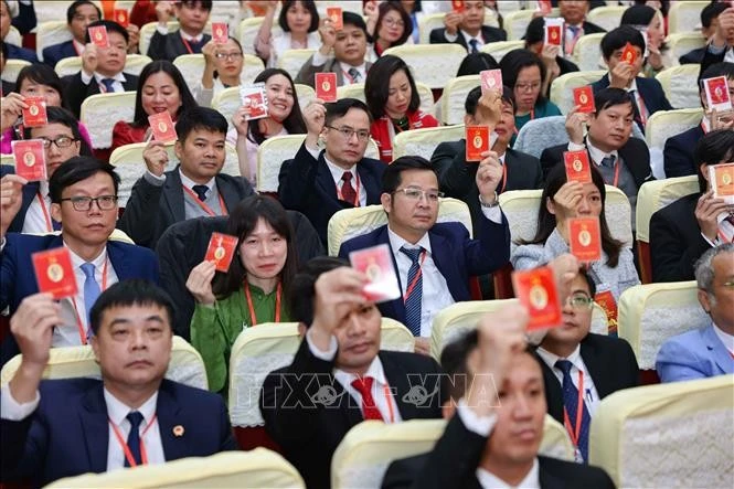 Đại biểu biểu quyết thông qua dự thảo Nghị quyết Đại hội. Ảnh: Thanh Tùng/TTXVN