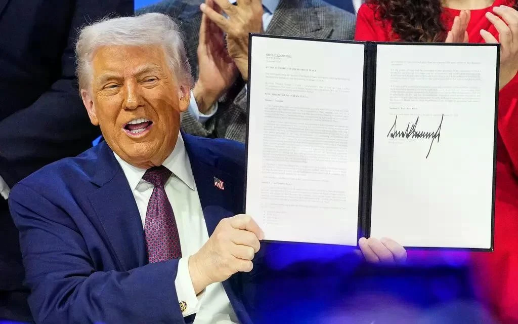 Tổng thống Mỹ Donald Trump cầm văn kiện sáng kiến “Hội đồng Hòa bình” tại Diễn đàn Kinh tế Thế giới ở Davos, Thụy Sĩ, ngày 22/1/2026 (Ảnh: AP)