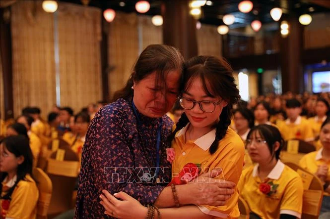 Người dân xúc động khi được thực hiện nghi thức cài hoa hồng lên áo để tưởng nhớ đấng sinh thành.