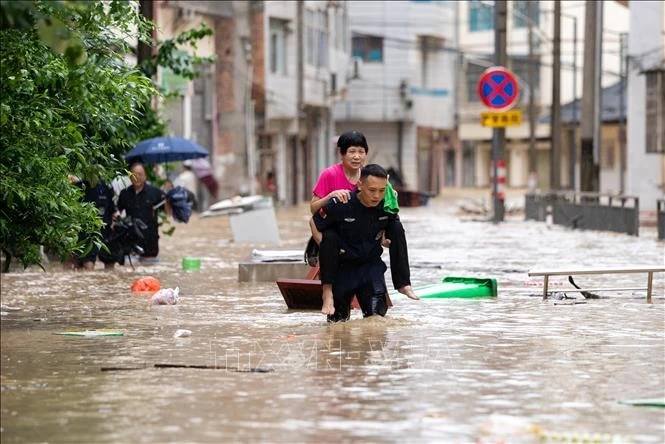 Lực lượng cứu hộ hỗ trợ người dân sơ tán khỏi khu vực ngập lụt tại huyện Tòng Giang, tỉnh Quý Châu, Trung Quốc ngày 24/6/2025.