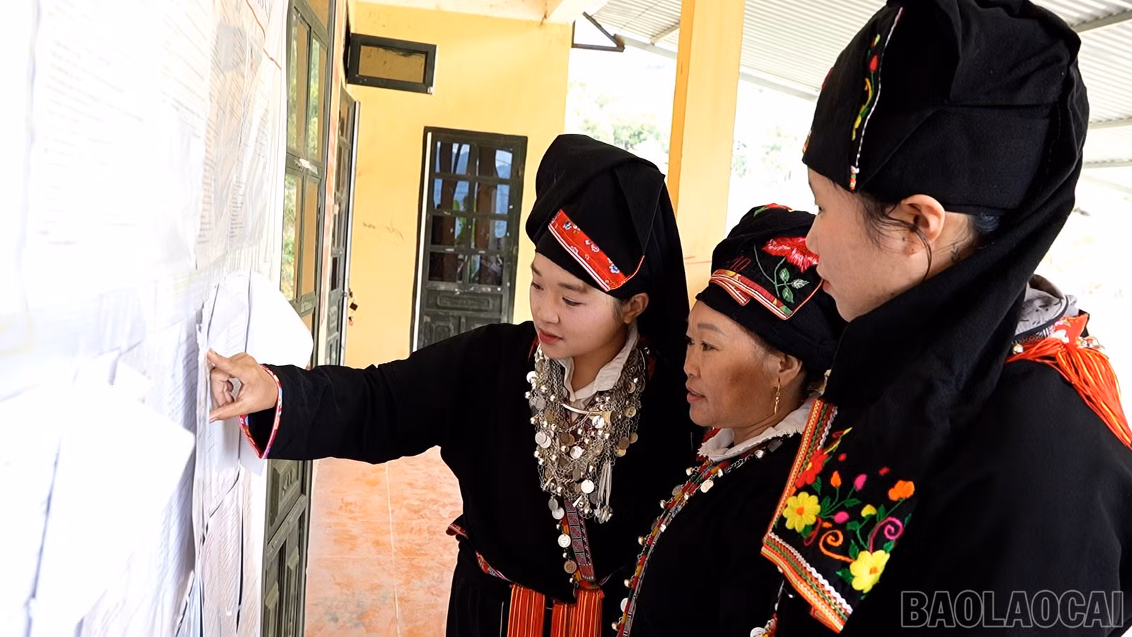 Người dân xã Sơn Lương tìm hiểu tiểu sử của các ứng cử viên.