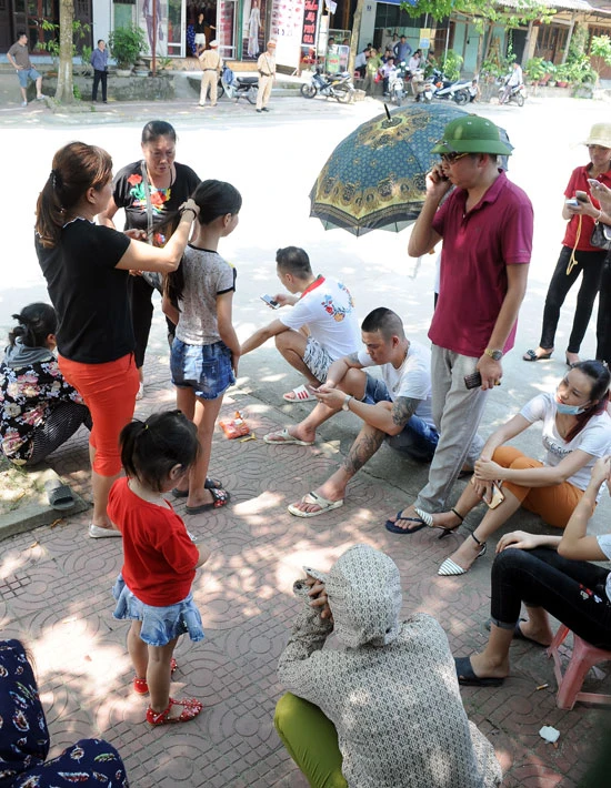 Các đối tượng tụ tập trước cổng UBND huyện.