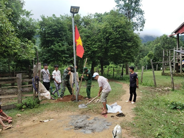  Cán bộ, chiến sĩ Đồn Biên phòng Làng Mô và đoàn viên, thanh niên thuộc Đoàn Thanh niên xã Trường Sơn xây dựng công trình “Ánh sáng vùng biên” tại bản Dốc Mây. Ảnh: Thanh Nam.