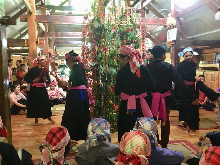 Ngôi nhà sàn của người Tày là không gian độc đáo, rộng rãi để tổ chức Đại pang. Bà con, hàng xóm cùng quây quần để lắng nghe thầy hát. Bà con cùng hỗ trợ, giúp đỡ gia đình chuẩn bị mâm cỗ và các linh vật, đồ dùng dâng trong ngày lễ. “Bóc va” được tổng hợp từ nhiều loại lá cây và treo thành một gian. Trong nghi lễ đây là cỏ để nuôi ngựa, nuôi rồng gửi cho các Quan các Tào. Những quả trứng được sơn màu dùng để trang trí trong đại lễ. Thứ quan trọng trong đại lễ là cỗ hoa. Cỗ hoa được đặt ngay gian giữa nhà, được trang trí từ măng, rau, củ mài, củ từ, trứng… Rót rượu để mời các Quan, các Tào xuống chứng giám. Đầu tiên, các thầy sẽ múa quanh cỗ hoa để “tỏn tang”, tức là phát đường cho Quan Tào ở Mường Trời xuống chứng giám đại lễ. Đội nhạc hỗ trợ trong đại lễ. Bà Hoàng Thị Lả hát mời quan. Các thầy sẽ hát, múa như vậy trong thời gian 3 ngày 2 đêm cho đến khi đón được quan xuống chứng giám và nâng cấp sắc cho bà.