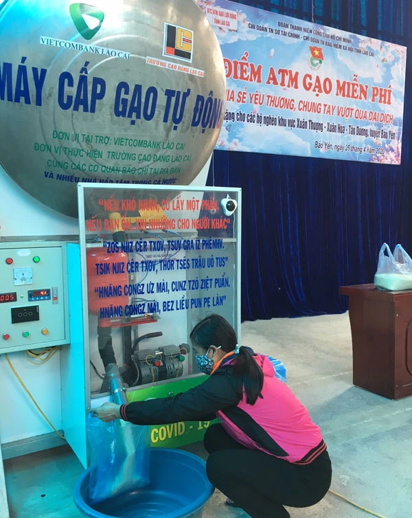 Người dân xã Xuân Hòa nhận gạo từ máy cấp gạo tự động.