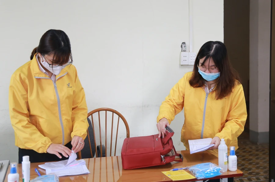 Cán bộ bưu điện chuẩn bị hồ sơ, giấy tờ trước khi đến nhà người dân.