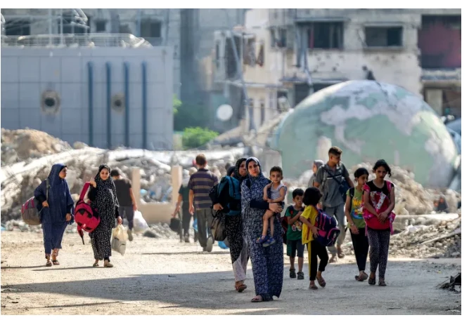 Người dân đi ngang qua đống đổ nát và các tòa nhà bị hư hại ở quận Tuffah thuộc phía Đông thành phố Gaza, ngày 8/7/2024.