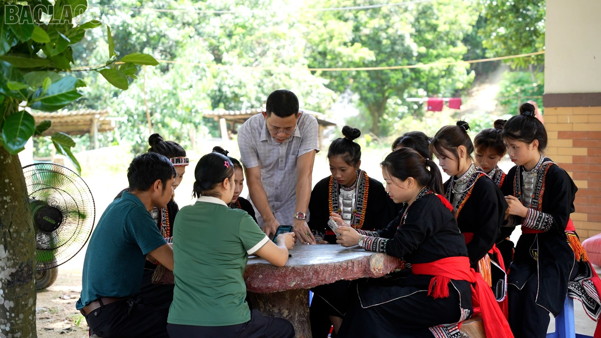 Lãnh đạoTrung tâm Phục vụ hành chính công xã Bảo Hà hướng dẫn bà con bản Bông 1-2 sử dụng dịch vụ công trực tuyến trên điện thoại. baolaocai-tl_2.jpg
