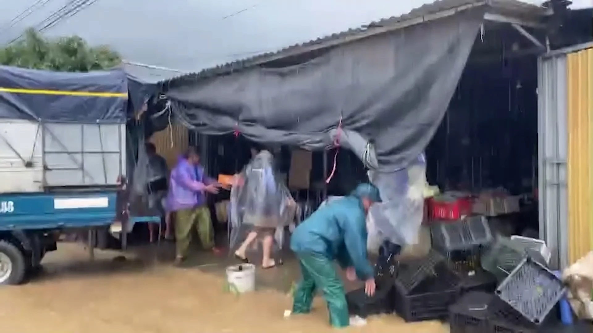 Lực lượng chức năng xã Tú Lệ hỗ trợ người dân di dời tài sản.