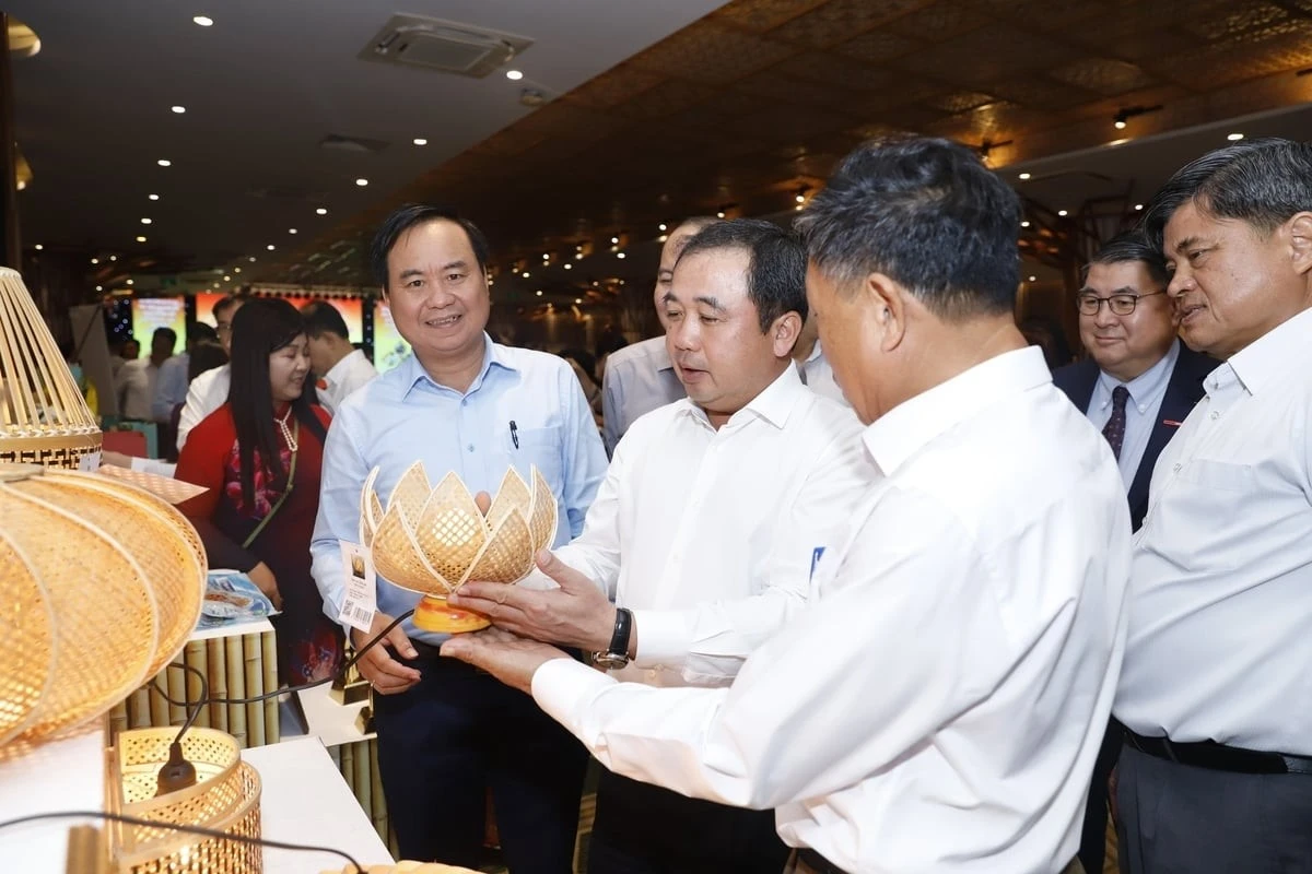 Quyền Bộ trưởng Trần Đức Thắng xem sản phẩm OCOP bộ đèn tre Đức Phong.