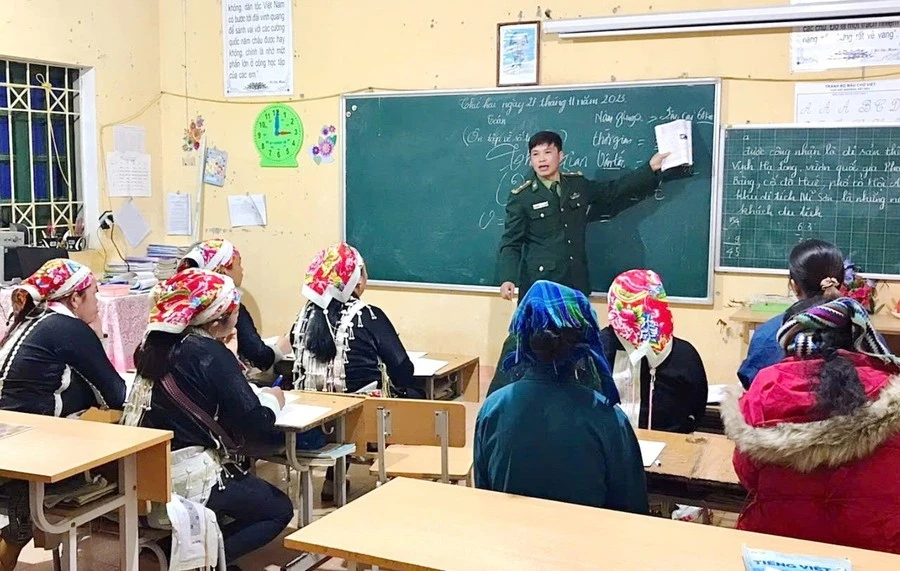Trung tá Đinh Thái Đạt trong một giờ lên lớp dạy học xóa mù chữ cho bà con.
