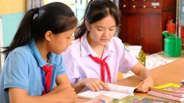 Gia Huệ (bên phải) giúp đỡ các bạn trong tổ về học tập. Học Bác 8.jpg
