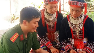 Thiếu tá Hoàng Vũ Trung hướng dẫn người dân cài đặt ứng dụng VNeID trên điện thoại thông minh.