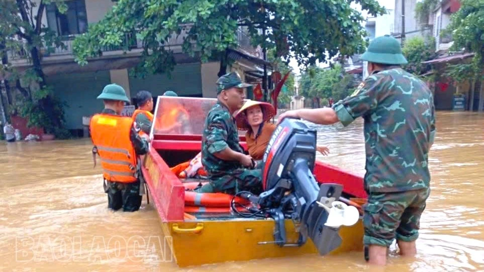 Cán bộ, chiến sĩ Ban Chỉ huy PTKV 5 - Mậu A sử dụng xuồng cứu hộ sơ tán người dân đến nơi an toàn.