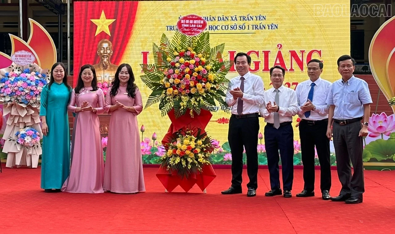 Đồng chí Dương Đức Huy - Ủy viên Ban Thường vụ, Trưởng Ban Tuyên giáo Tỉnh ủy cùng các thành viên đoàn công tác tặng hoa chúc mừng Trường THCS số 1 Trấn Yên.