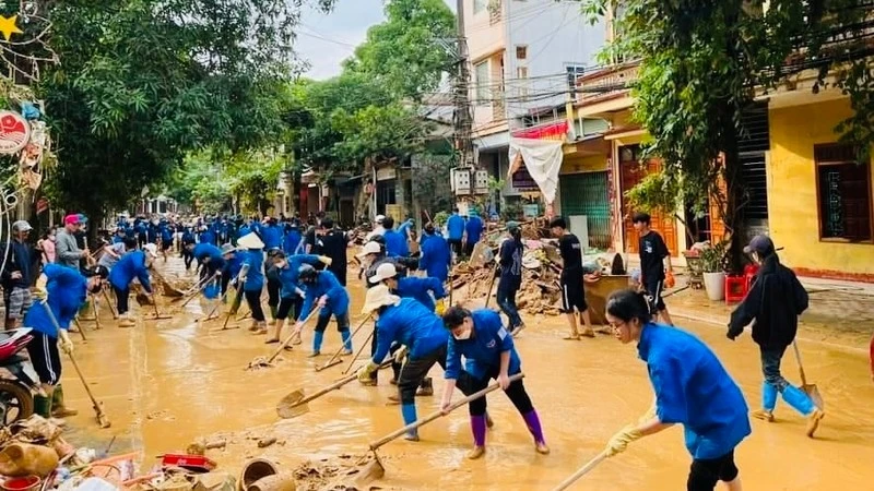 Thanh niên tình nguyện Yên Bái tham gia vệ sinh môi trường tại thành phố Yên Bái sau khi báo chão số 3 đi qua.