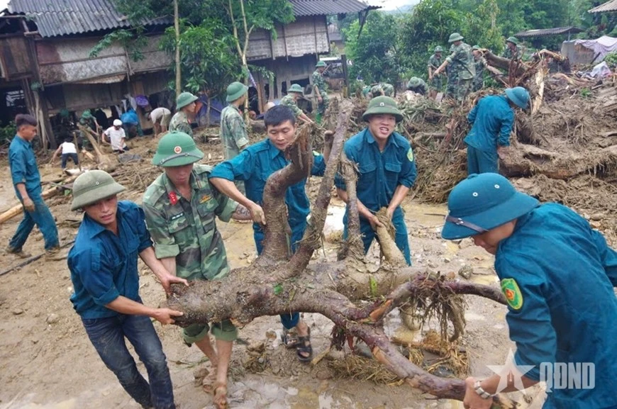 Cán bộ, chiến sĩ Bộ CHQS tỉnh Lào Cai giúp đỡ nhân dân khắc phục hậu quả thiên tai.